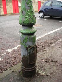 Old cast iron lamp post, with ornate detail on base