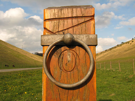 Waymarker of wood with ringed metal detail