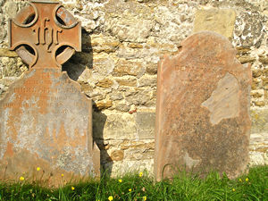 Headstones against church wall, Nunburnholme