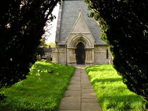 St Giles, Skelton, doorway framed by churchyard yews
