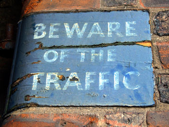 Painted sign on wall - Beware of the Traffic