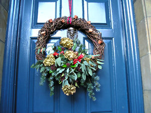 Festive wreath on a handsome blue-painted front door