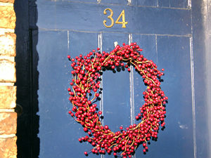 Festive wreath – red berries on blue door