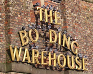 Pigeons perched on the sign for the Bonding Warehouse (now missing its 'N')