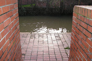This rather utilitarian brick marks the entrance to . . .