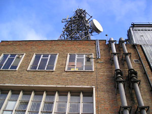 Looking up: the old telephone exchange and its communications mast.