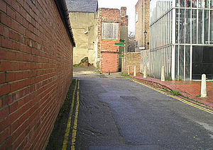 Alongside the old telephone exchange on Garden Place, looking towards the entrance to Straker's Passage.