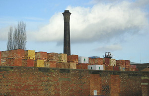 It's that chimney again – seen over stacks of bricks in Walker's yard. Taken in Navigation Road, 25 January 2004