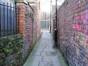 Lovely old brick walls of Straker's Passage, continuing to the entrance opposite the old telephone exchange.