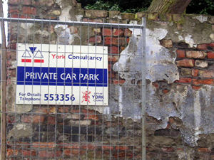 Crumbling wall and Private Car Park notice