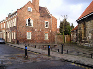 Houses on St Andrewgate. The refurbished church is visible on the right.