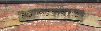 Carved inscription above doorway – 'Pro aris et focis'