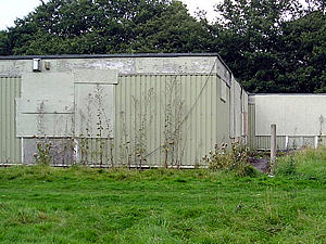 Boarded-up prefabricated building, towards the rear of the site