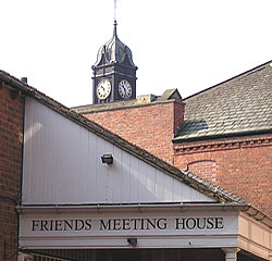 Law courts tower peeking over the roof of the Friends' Meeting House