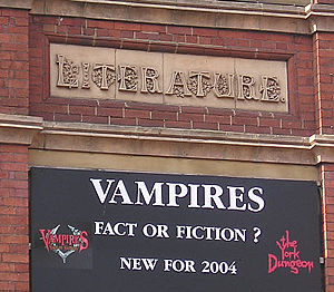 Building detail: inscription reads 'LITERATURE' and sign beneath advertises the York Dungeon