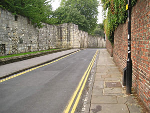 View along Marygate showing old abbey wall