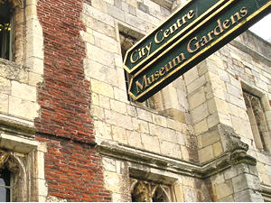 Handsome signpost by lodge at gate to Museum Gardens