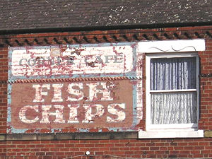 Painted sign on wall: Corner Cafe – Fish Chips