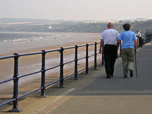 Couple walking on Filey seafront