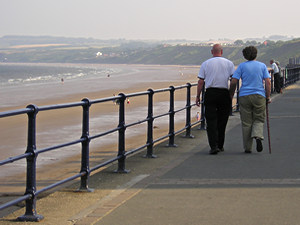 Couple walking on Filey seafront